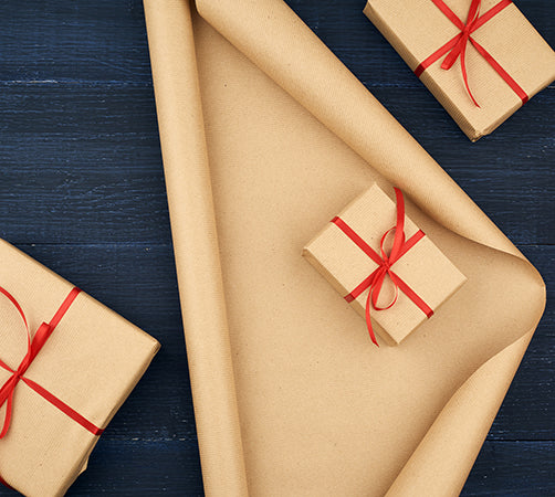 brown kraft paper gift wrapping with red ribbon